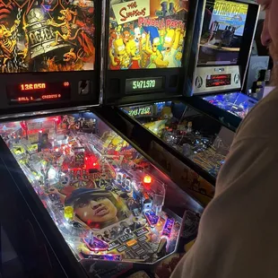 a man playing a pinball game