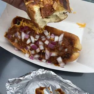 Chili cheese onion and spicy mustard hotdogs