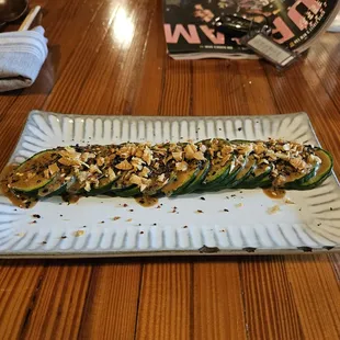 a plate of stuffed zucchini on a wooden table