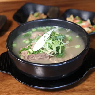 a bowl of soup with meat and vegetables