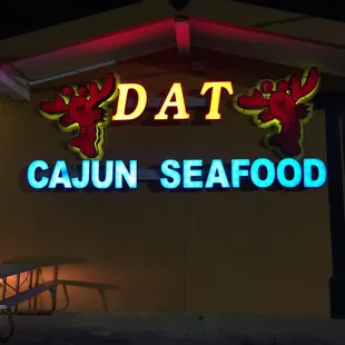 a neon sign for dat cajun seafood
