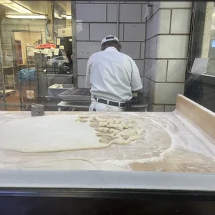 Clear view of donuts being freshly made in the front window.