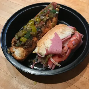 Half eaten hoagie and a Steak Sandwich w/hot and sweet peppers