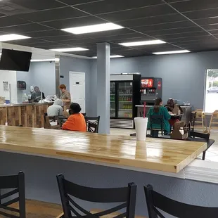 people sitting at a counter in a restaurant