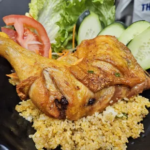 Fry whole chicken thigh over butter rice.