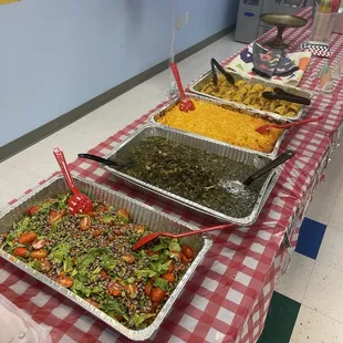 Trays of black eyed peas salad, collard greens, Mac n cheese, corn on the cob