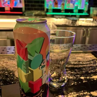 a can and a glass on a counter