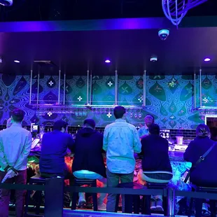 a group of people sitting at a bar