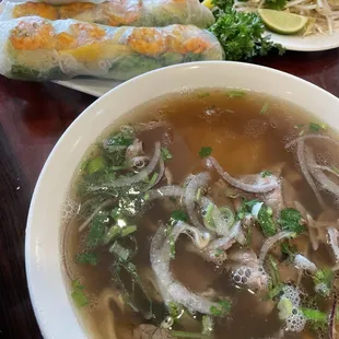 pho order with summer rolls, notice the mango inside and long stems of parseley