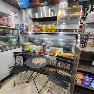 a table and chairs in a deli