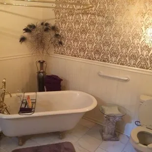 Gorgeous bathroom with claw foot tub and converted armoire sink