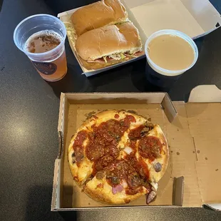 a box of pizza and a cup of coffee
