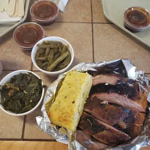 Baby back ribs plate with collards, green beans, and corn bread