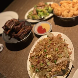 a plate of fried rice with meat and vegetables