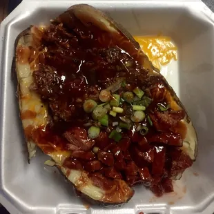 Baked potato with spicy sausage &amp; brisket... Delicious!  More than enough for 2 greedy MF's to share.