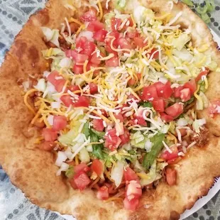 This is one of our popular items. The Indian Taco. It&apos;s on a frybread with red Chile beans, cheese, lettuce, tomatoes and onions.