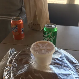 a cup of coffee and a can of soda