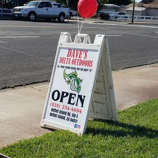 Open sign by street.