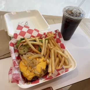 Cheeseburger on a pretzel bun and fries