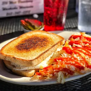 Bacon Egg &amp; Cheese Sandwich, with hash browns ($7.50). Served street side and employee was wearing a mask.