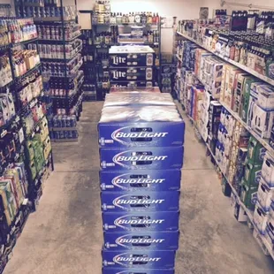 a large stack of cans of beer