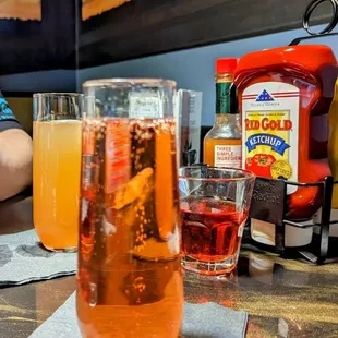 a woman sitting at a table with drinks