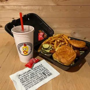 a burger and fries with a drink