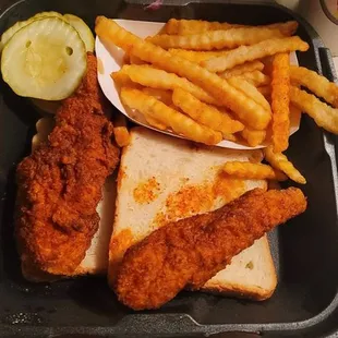 #pleAsed..pickles come w/every meal. The bread in the picture is red, but not wet from liquid. &quot;DAVE&apos;S HOT CHICKEN&quot;!!!!! OUCH