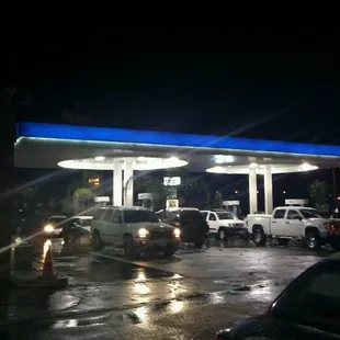 a view of a gas station at night
