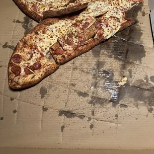 two slices of pizza in a box