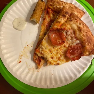 two slices of pepperoni pizza on a paper plate