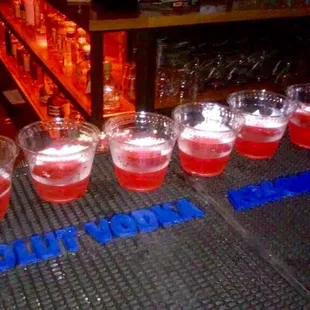 a row of shot glasses on a bar