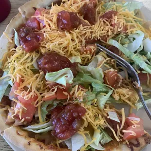 The personal size taco pizza  with salsa on top