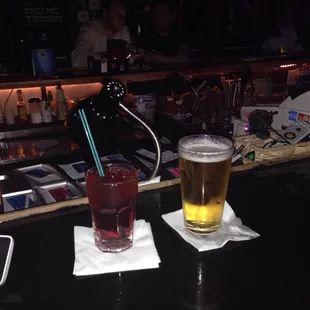 two glasses of beer on a bar