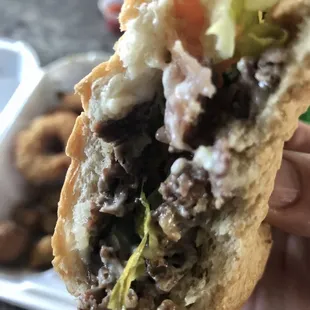 a hand holding a sandwich