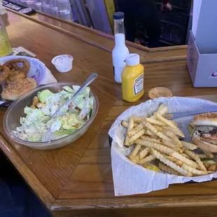 Two 1/4lb Burgers, one with fries one with onion rings. The House Salad.
