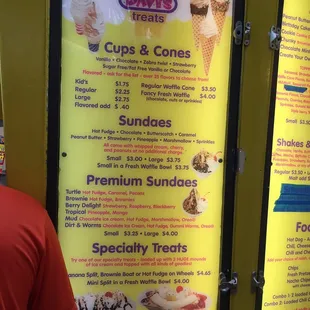 a man standing in front of a menu