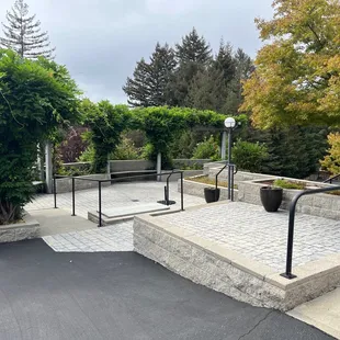 a view of a patio with a bench and trees