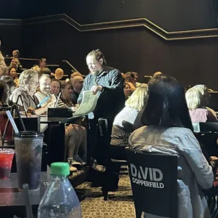 People signing paper prior to show start.