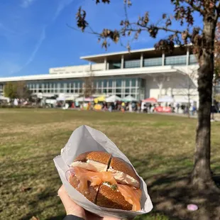 a hand holding a sandwich
