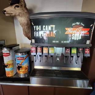 a beer dispenser with a deer head mounted on it