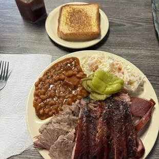 Three meat plate: ribs, sausage, and brisket.