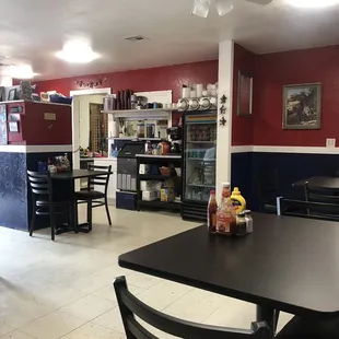 a dining area with tables and chairs