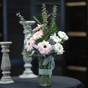 Send this bedazzled arrangement of pink and white gerberas designed in a accented jeweled vase...