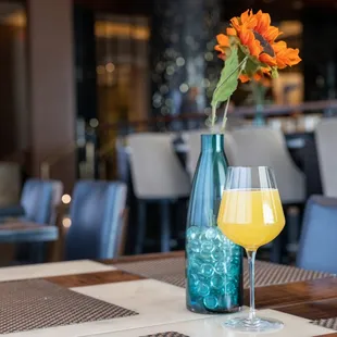 a glass of beer and a vase of flowers