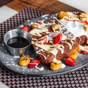 a plate of french toast with strawberries and nuts