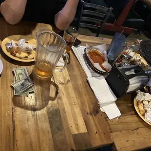 a man eating pizza and drinking beer