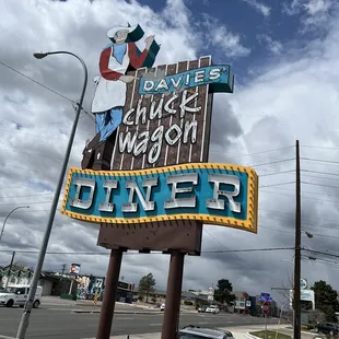  car parked in front of the sign