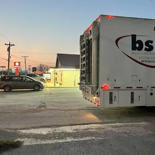 a delivery truck parked at a gas station