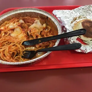 a plate of spaghetti and a sandwich